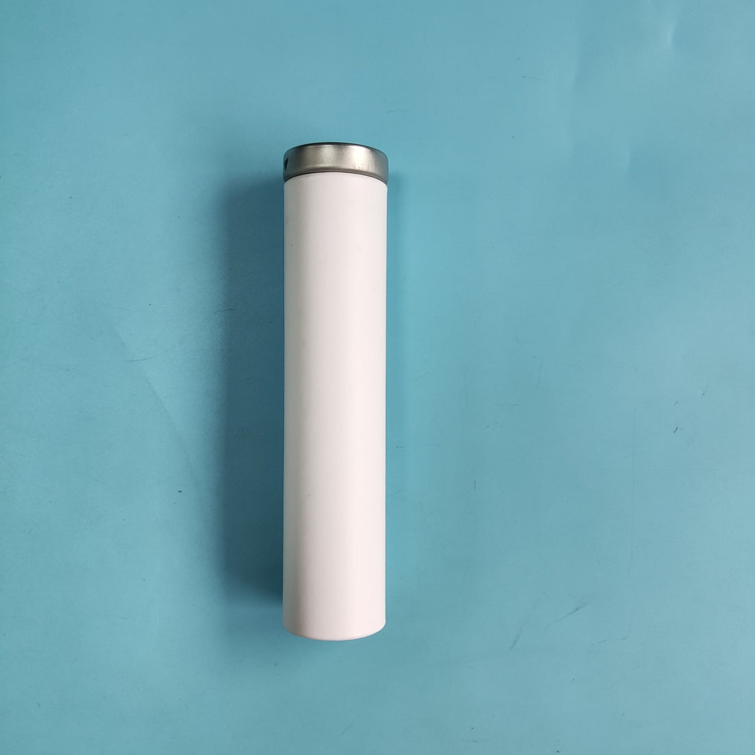 A vape pen securely placed inside a child-resistant paper tube with a metal lid, showcasing eco-friendly and safe packaging design.