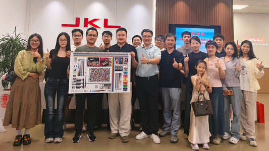 COSOURCE team and training participants holding a print test sheet during a printing factory visit