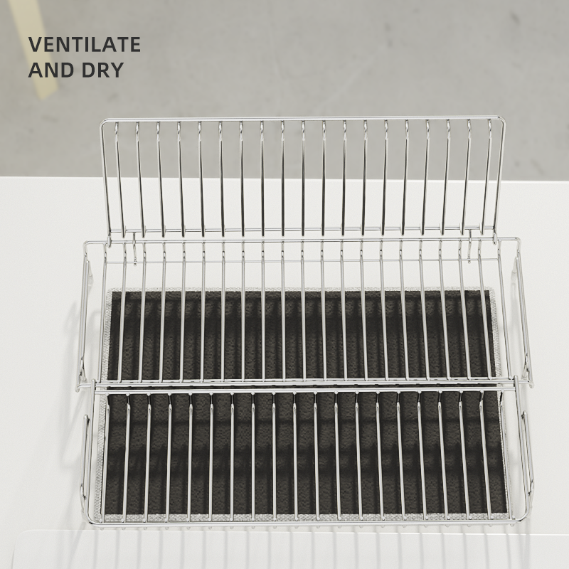 Metal dish rack with black mesh trays on a white surface