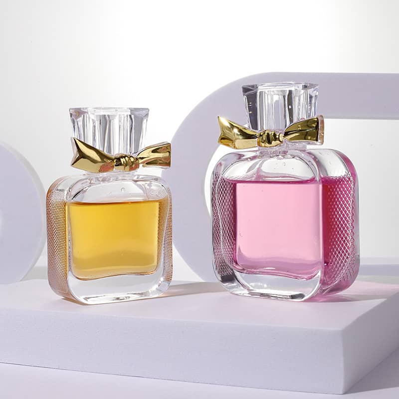 Cosource flat glass perfume bottle 50ml with golden bow filled with yellow and pink fragrance liquids