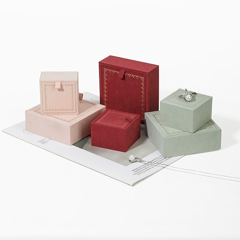 Closed elegant jewelry box with satin ribbon pull, perfect for custom packaging